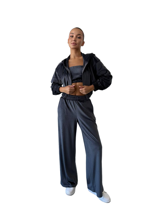Person wearing a black tracksuit on a white background
