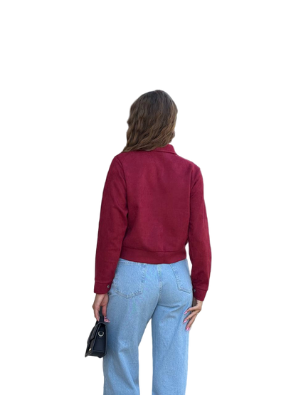 Person wearing a red jacket and blue jeans on a white background