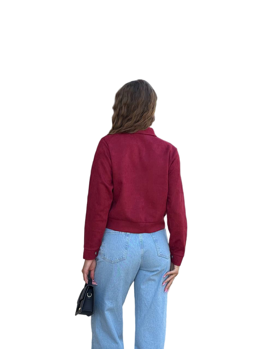 Person wearing a red jacket and blue jeans on a white background