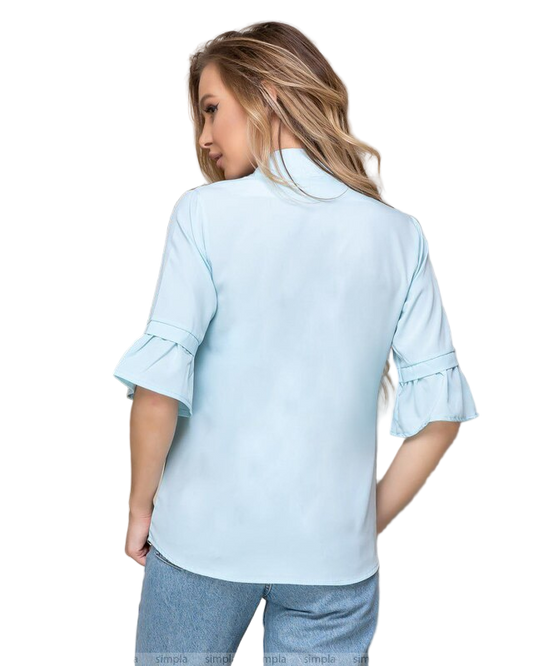Woman wearing a light blue blouse with ruffled sleeves on a white background