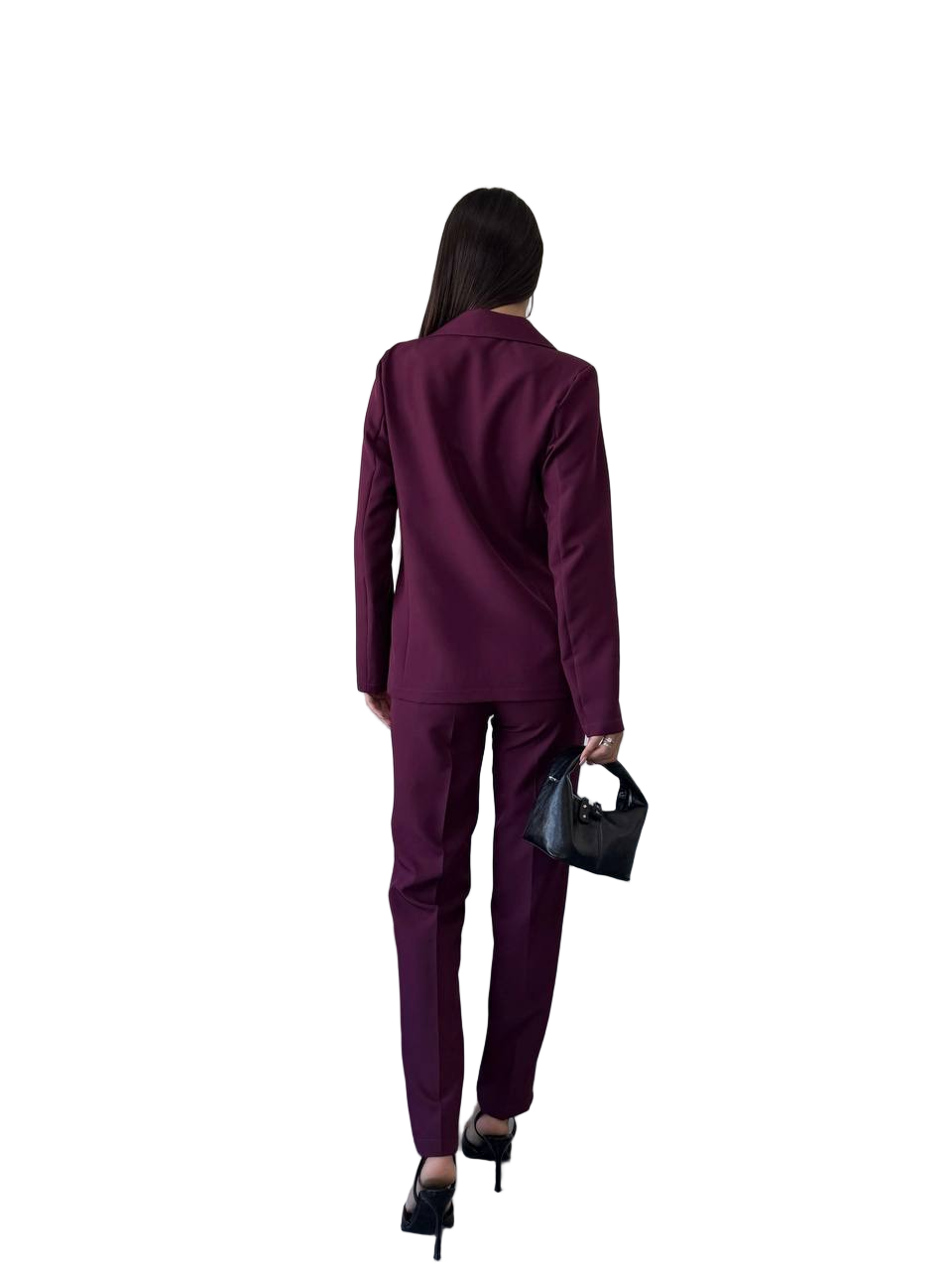 Person wearing a purple suit holding a black handbag on a white background