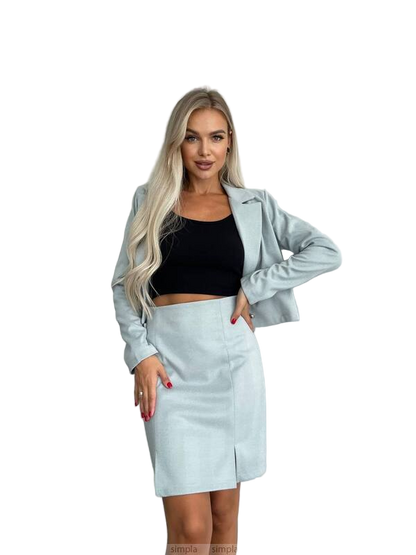 Woman wearing a light blue jacket and skirt set on a white background