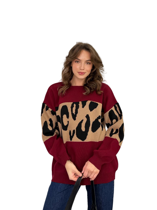 Woman wearing a maroon sweater with leopard print pattern on a white background