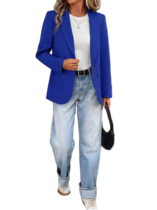 Person wearing a blue blazer, white shirt, and jeans with a black handbag on a white background.