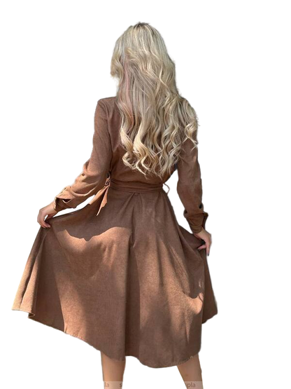 Woman wearing a brown dress with long sleeves on a white background