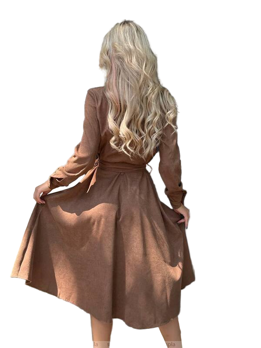 Woman wearing a brown dress with long sleeves on a white background