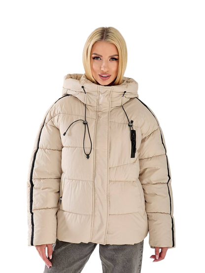 Woman wearing a beige puffer jacket with black accents on a white background