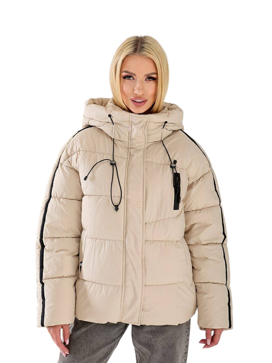 Woman wearing a beige puffer jacket with black accents on a white background