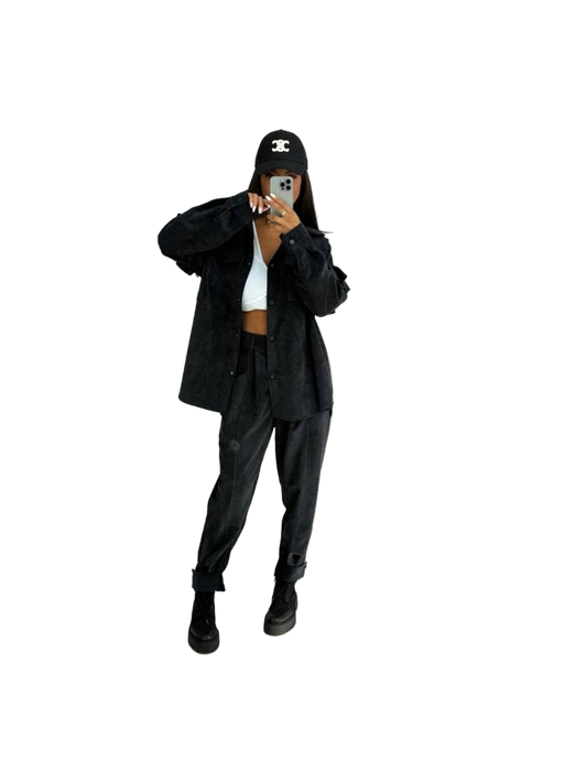 Person wearing a black outfit with a white background