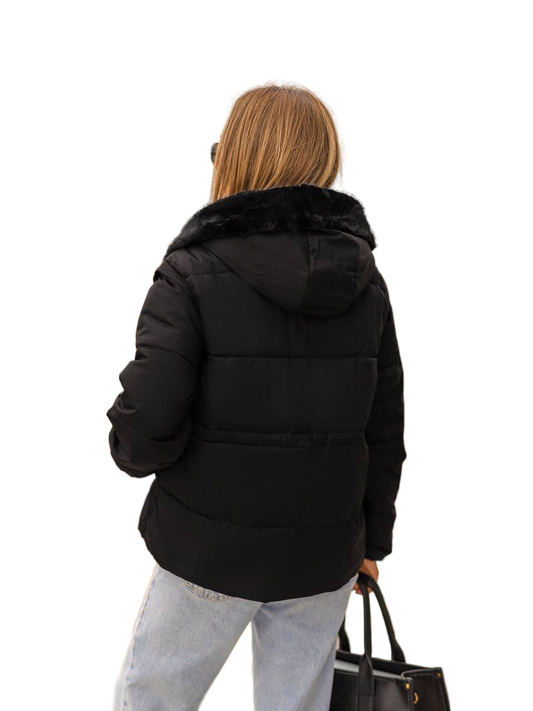 Person wearing a black puffer jacket with fur hood on a white background