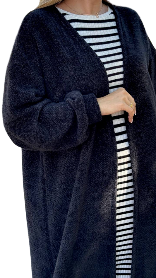 Person wearing a navy cardigan over a striped shirt on a white background