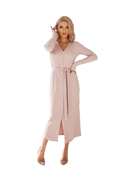 Woman wearing a long light pink dress on a white background