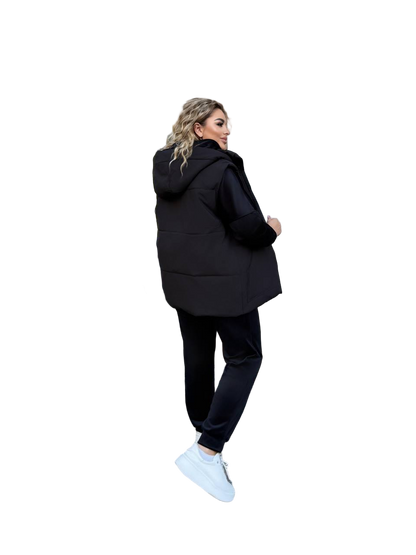Woman wearing a black hoodie and pants on a white background