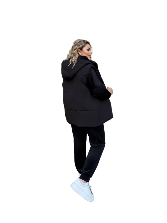 Woman wearing a black hoodie and pants on a white background