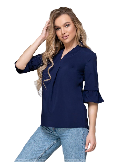 Woman wearing a navy blue blouse with ruffled sleeves on a white background