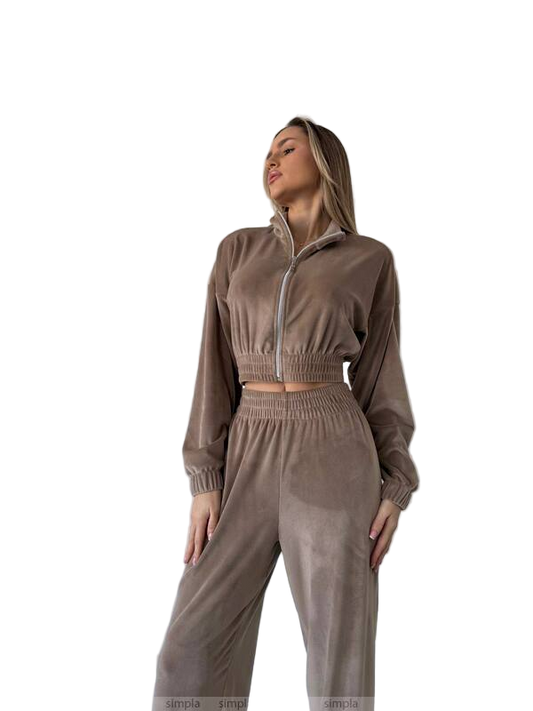 Woman wearing a brown tracksuit on a white background