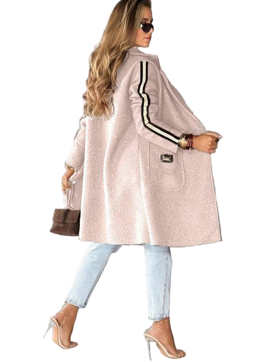 Woman wearing a light pink coat with black stripes on a white background