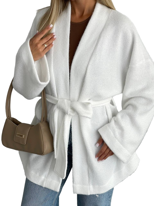 Person wearing a white robe with a brown handbag on a white background