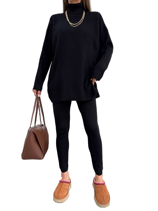 Person wearing a black outfit with a brown bag and shoes on a white background