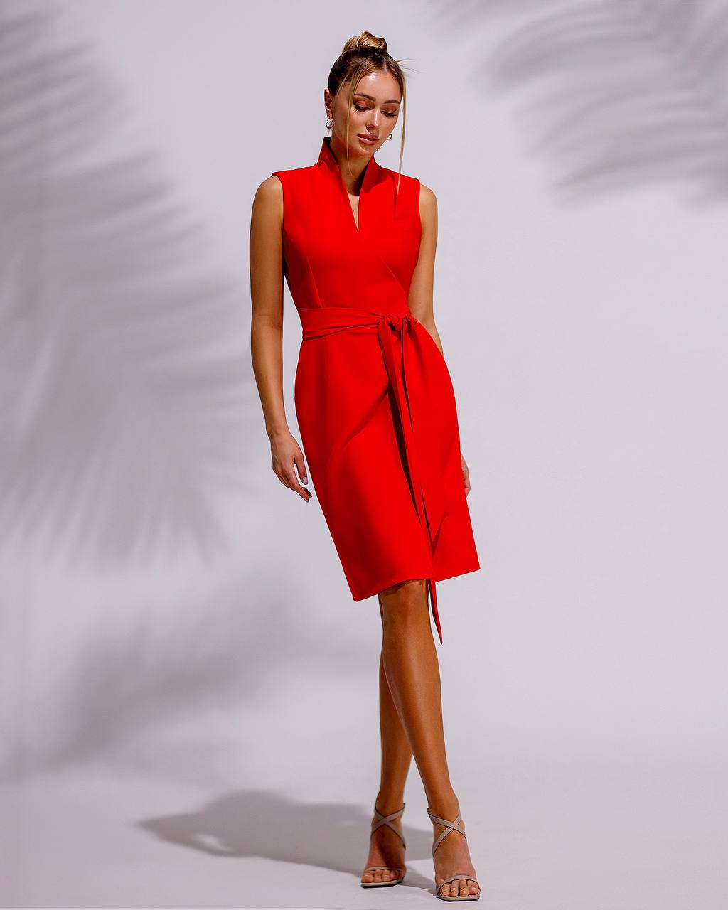 Woman wearing a red dress against a gray background