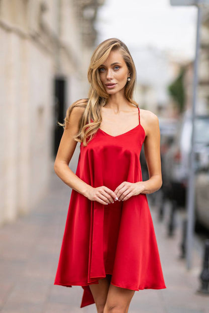 Woman wearing a red dress on a blurred street background