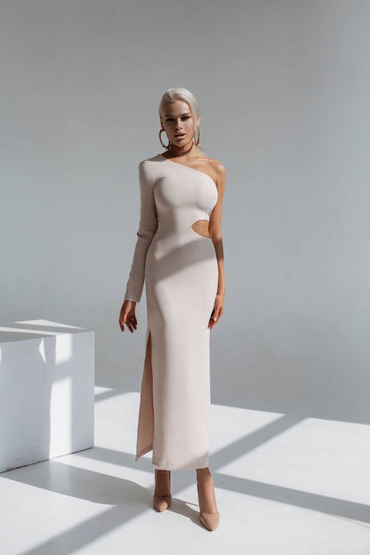 Woman wearing a one-shoulder dress with a cutout design in a minimalistic setting