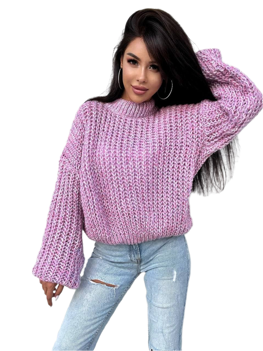 Woman wearing a pink knitted sweater and light blue jeans on a white background