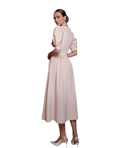 Woman wearing a light pink dress on a white background
