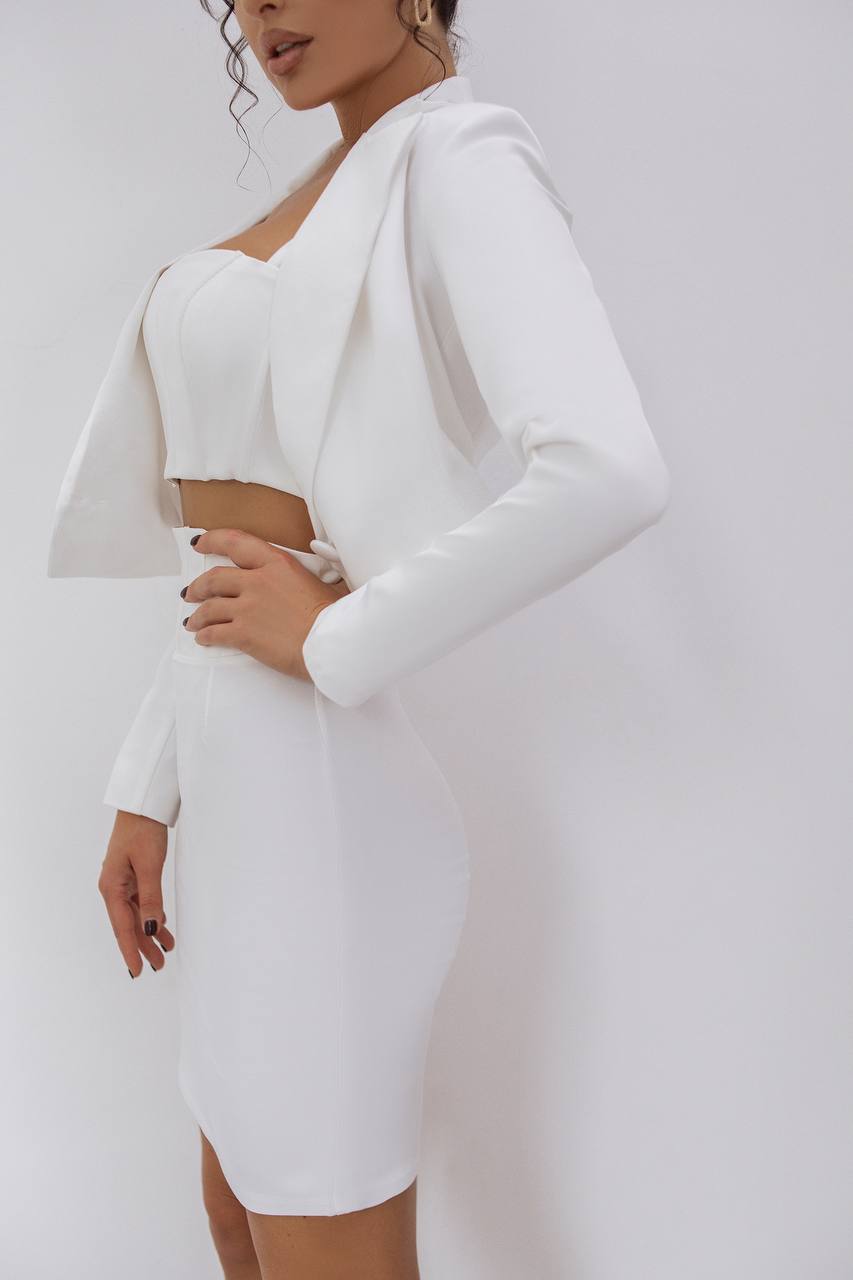 White dress with long sleeves on a plain background