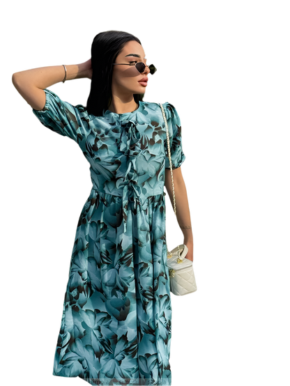 Woman wearing a blue floral dress on a white background