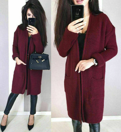 Woman wearing a burgundy cardigan with a plain background