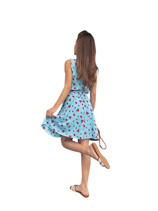 Woman wearing a blue dress with red floral pattern on a white background