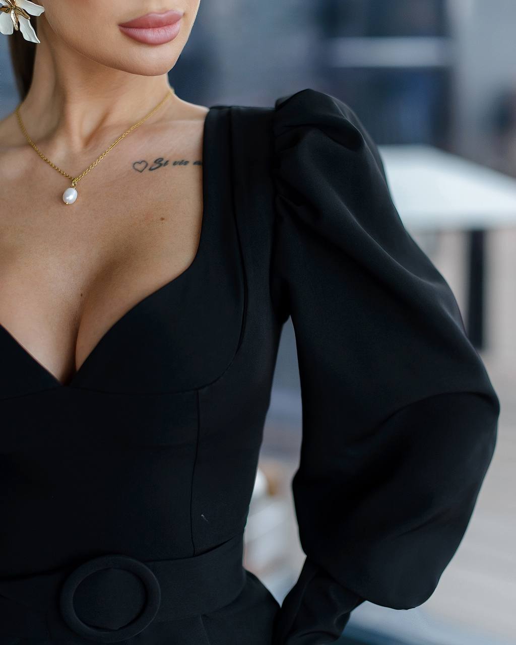 Person wearing a black outfit with a blurred background