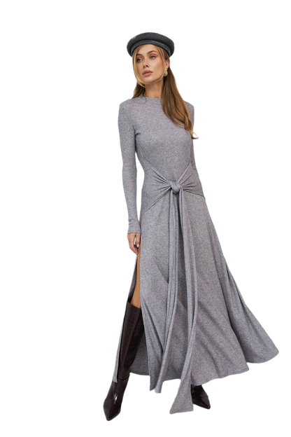 Woman wearing a gray long-sleeve dress with a knot detail on a white background