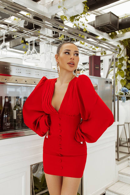 Woman in a red dress standing in a kitchen setting