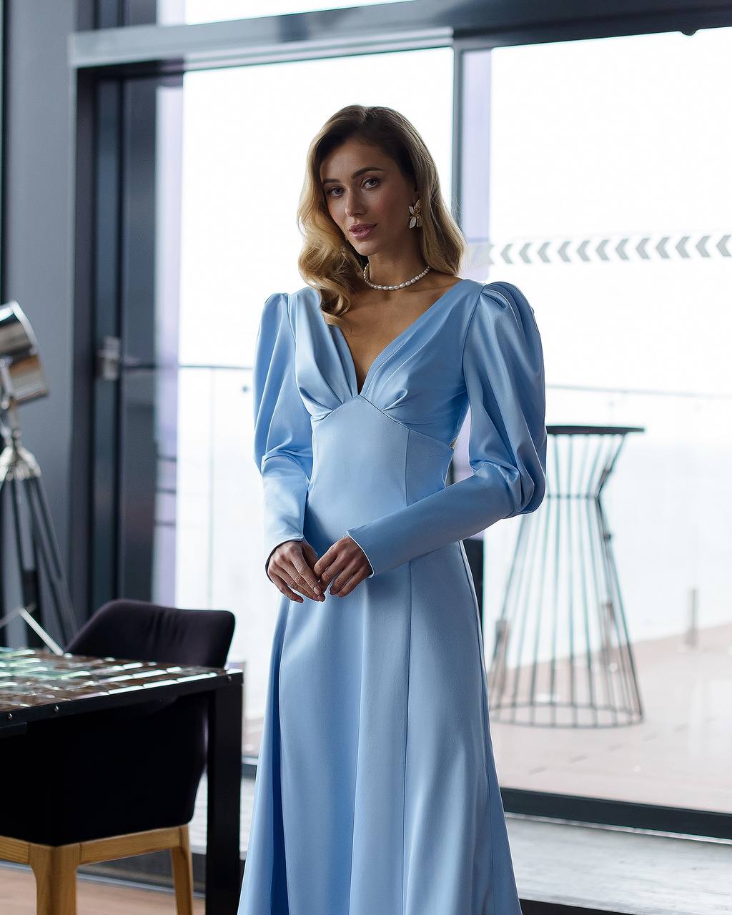 Woman wearing a light blue dress in an indoor setting
