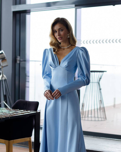 Woman wearing a light blue dress in an indoor setting
