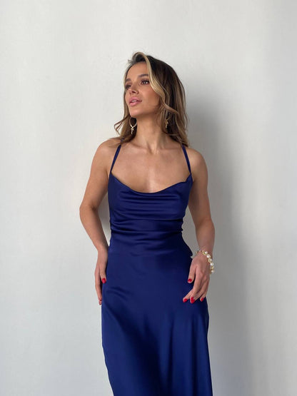 Woman wearing a blue dress against a plain background