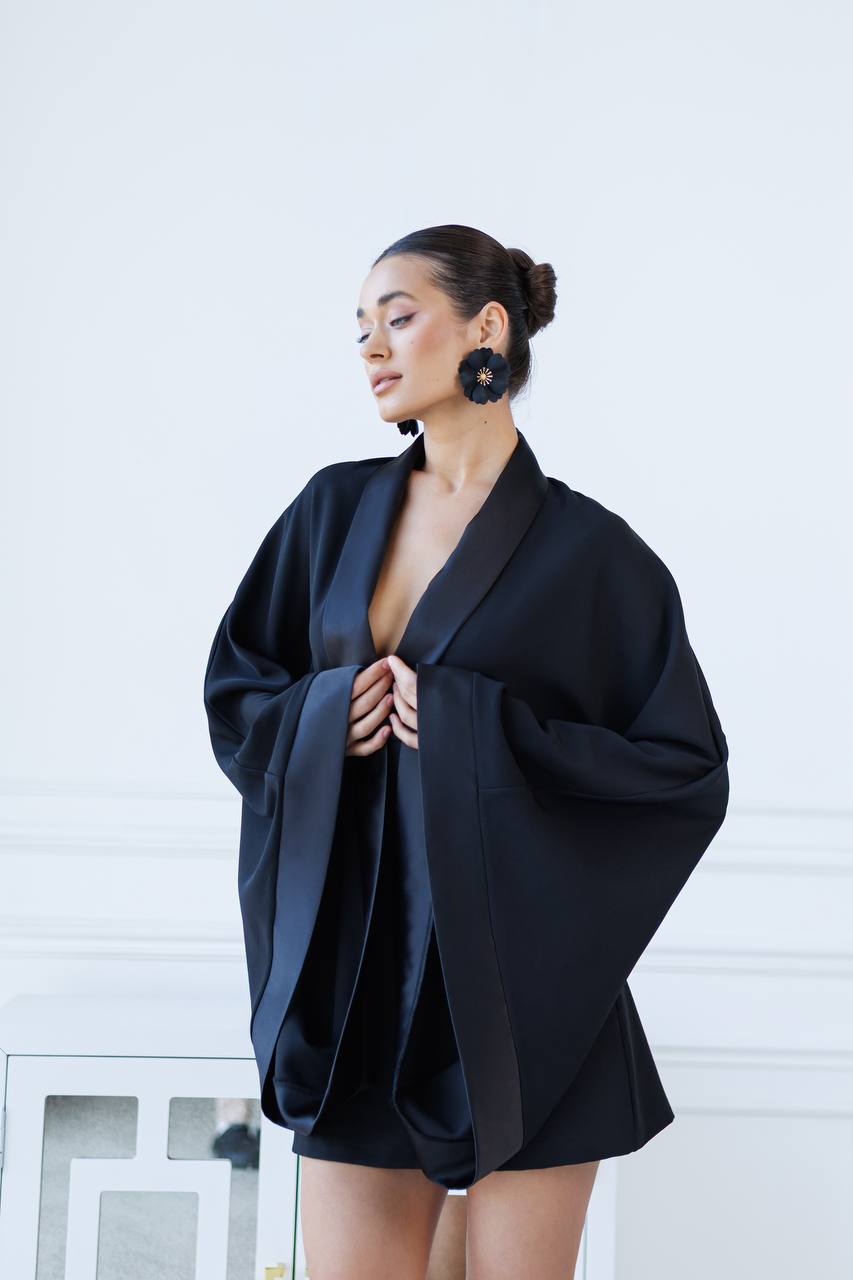 Woman wearing a black outfit with a white background