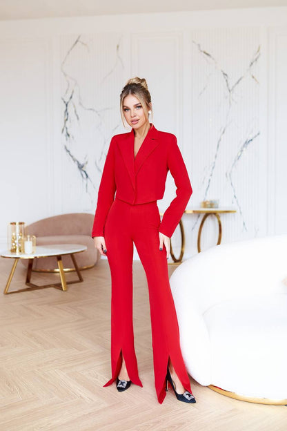Woman in a red outfit standing in a modern interior setting