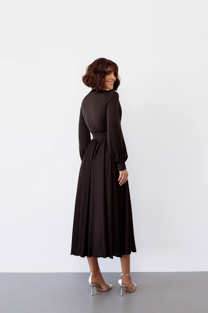 Woman wearing a black dress against a white background