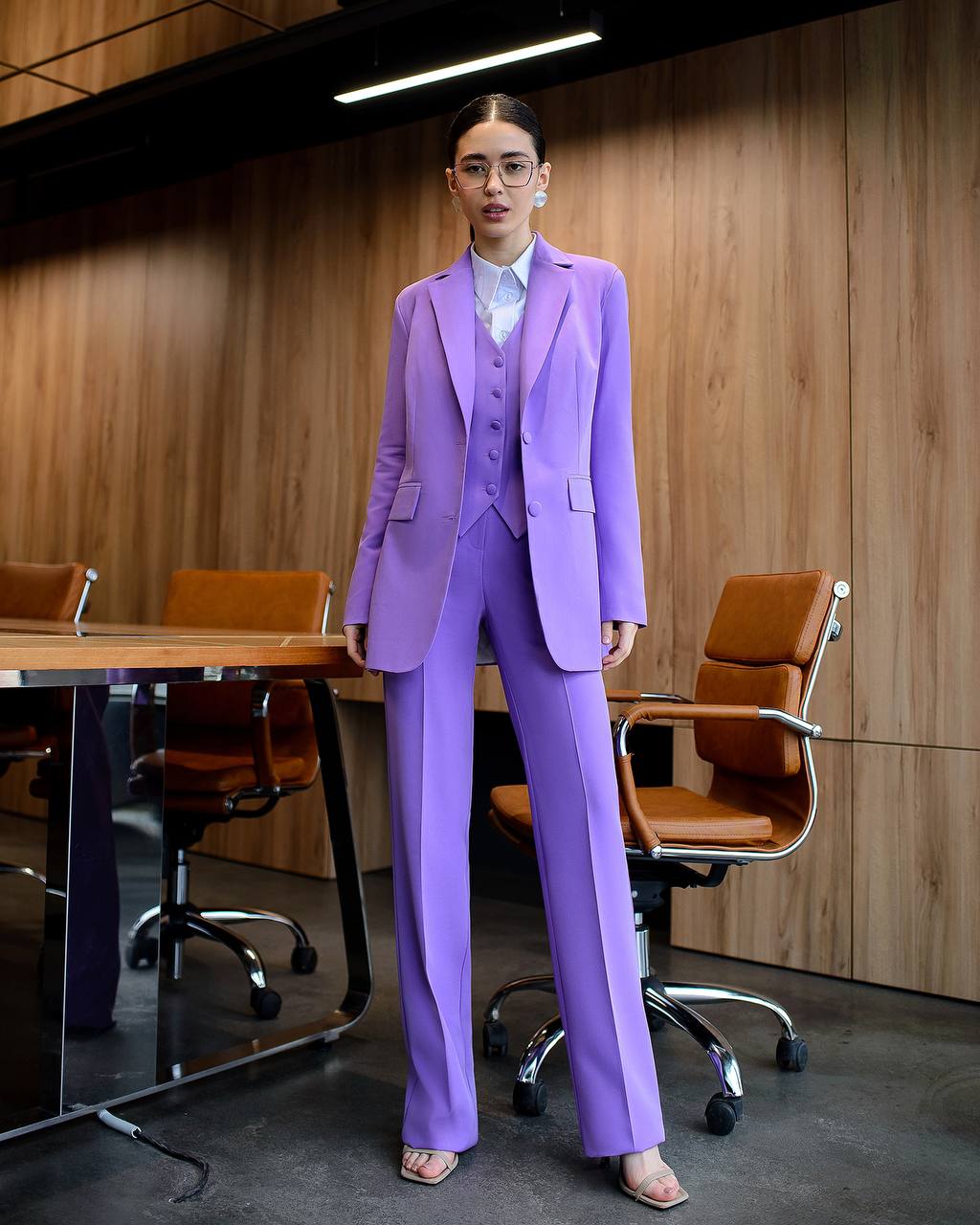 Person wearing a purple suit in an office setting