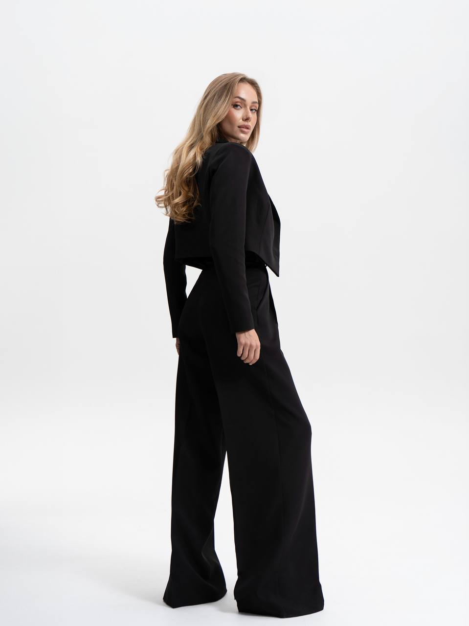 Woman wearing a black outfit on a white background