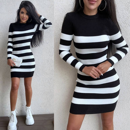Black and white striped dress worn by a model against a neutral background