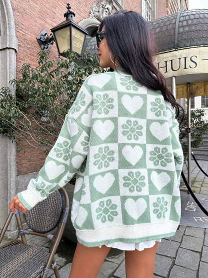 Person wearing a green and white patterned sweater outdoors.