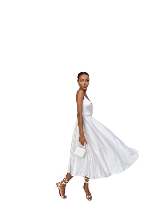 Woman wearing a white dress with a plain background