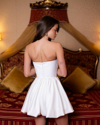 Woman in a white dress standing in a room with ornate decor