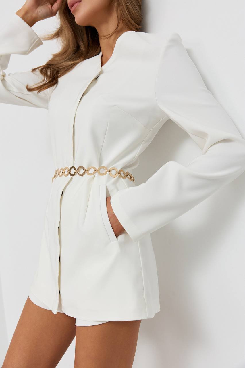 White blazer with gold belt on a plain background