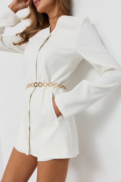 White blazer with gold belt on a plain background
