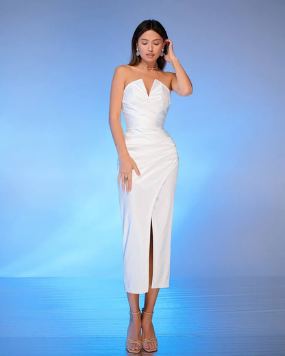 Woman wearing a white strapless dress with a blue gradient background